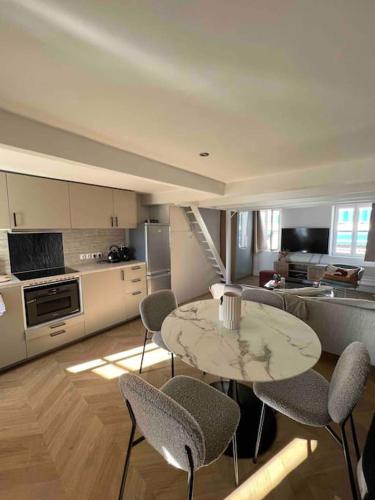 une cuisine avec une table et des chaises dans une pièce dans l'établissement «Entre Terre et Mer » 5mins à pied Plage/15mins Vieux Port, à Marseille