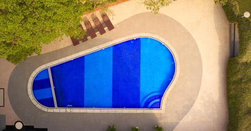 an overhead view of a building with a blue window at Vivanta Vadodara in Vadodara