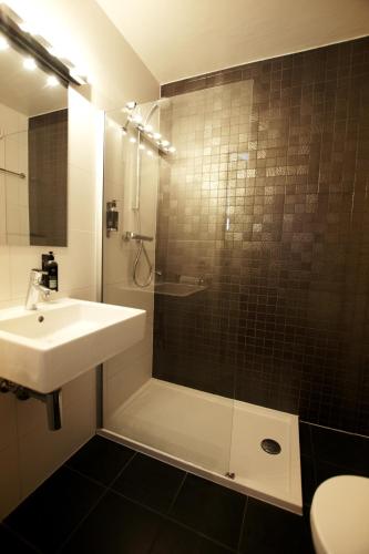 a bathroom with a sink and a shower at Trip Inn Eden Antwerpen in Antwerp
