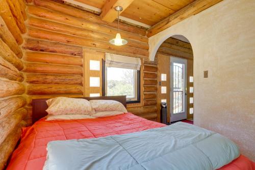 a bedroom with a bed in a log cabin at Pet-Friendly and Secluded Regina Cabin! in Regina