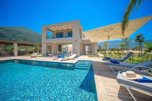 a villa with a swimming pool and a house at Claire villa in Sami