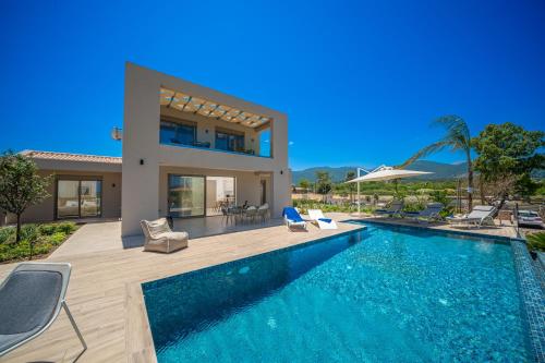 a villa with a swimming pool and a house at Claire villa in Sami