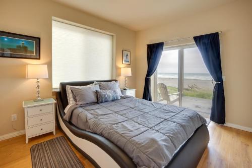 a bedroom with a bed with a view of the ocean at Gold Beach Retreat Private Hot Tub and Ocean Views! in Gold Beach