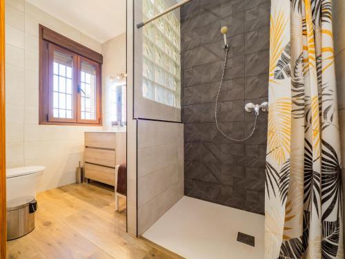a shower with a glass door in a bathroom at Cubo's The Secret Almogia Mountain View in Málaga