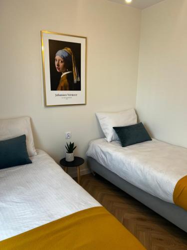 Ένα ή περισσότερα κρεβάτια σε δωμάτιο στο Apartament Szmaragdowy.