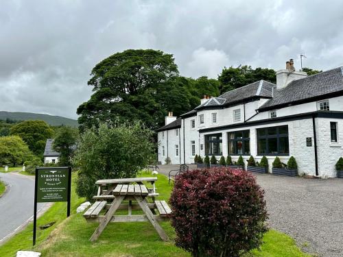 a picnic table in front of a building at The Strontian Hotel in Strontian