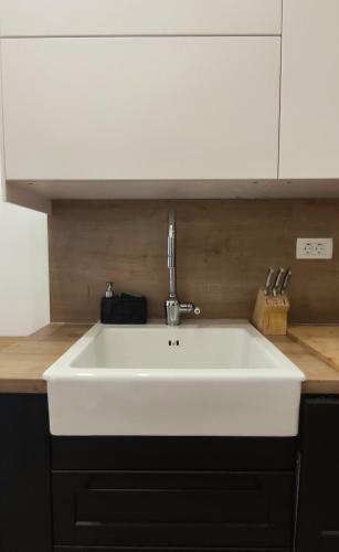 a white sink in a kitchen next to a counter at Panoramic spacious 3 bedroom apartment in Sumartin