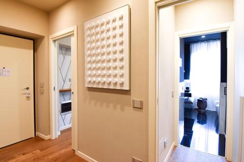 a hallway with a door with a picture on the wall at Nuova Cafe' Suite in Salice Terme
