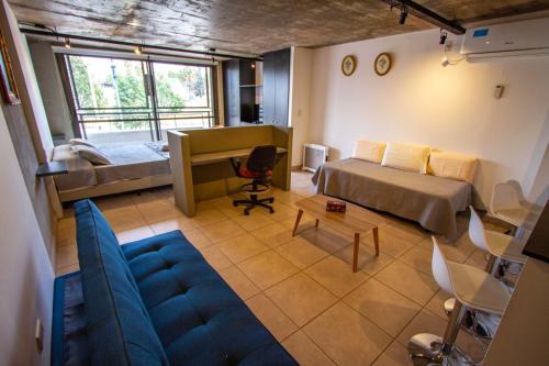 a living room with a couch and a bed and a desk at Espectacular Loft a estrenar !! in Godoy Cruz
