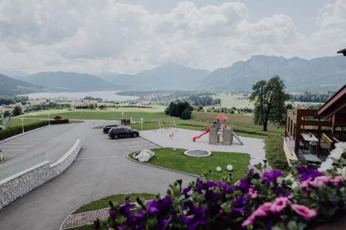 a view of a parking lot with a playground at Panorama Hotel Gasthof Leidingerhof in Mondsee