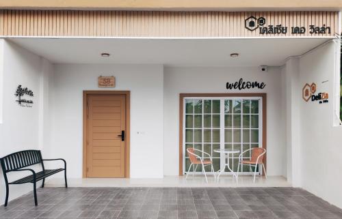 a waiting area with a table and chairs in a building at DeliZia de Villa Satun พักได้ 9 ท่าน in Satun