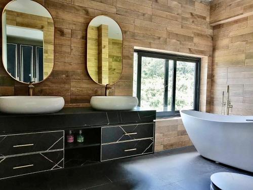 a bathroom with two sinks and a tub and two mirrors at 苏梅岛观景台海景別墅Golden Coconut Villa 5 超级海景 私密泳池 接送服务 in Koh Samui 