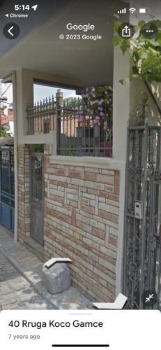 a house with a gate and a brick wall at Foleza in Korçë