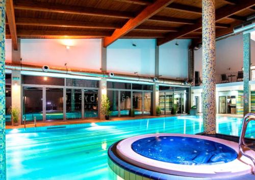 a large swimming pool with a hot tub in a building at Myto apartments Chopok, apartment Tereza in Mýto pod Ďumbierom