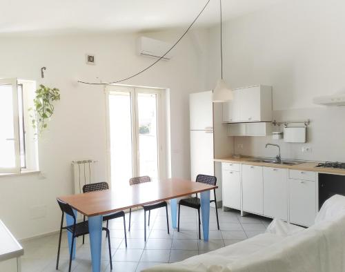 a kitchen with a table and chairs in a room at Appartamento vacanze San Salvo in San Salvo