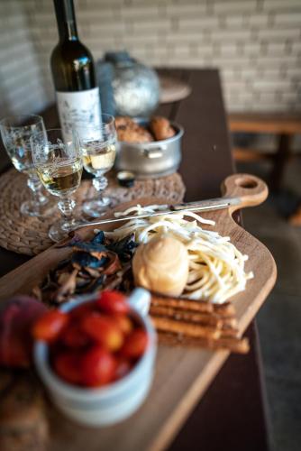 a table with a bunch of food and glasses of wine at Chalupa Morava in Veselí nad Moravou