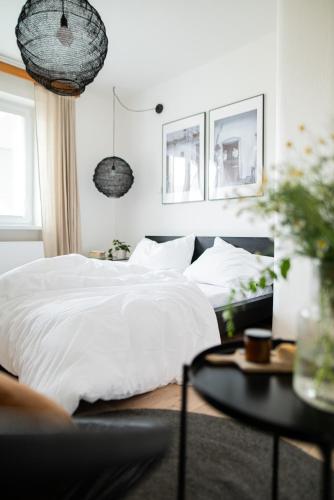a bedroom with a white bed and a table at Chalupa Morava in Veselí nad Moravou