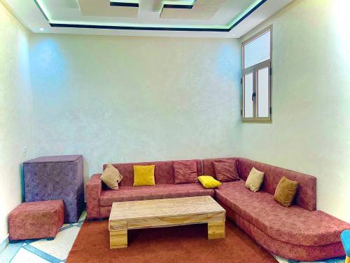 uma sala de estar com um sofá e uma mesa de centro em Résidence Othmane em Dakhla