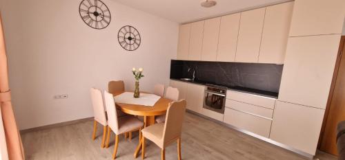 a kitchen with a table and chairs in a room at Apartments Stengl in Rab