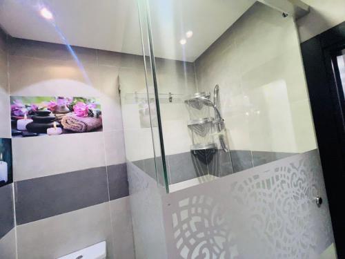 a bathroom with a shower with a glass door at Calm Apartment in Mazola next to Aeria Mall & Casa Finance City in Casablanca