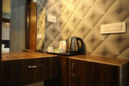 a coffee maker on a counter in a room at THE JAMAWAR in Srinagar