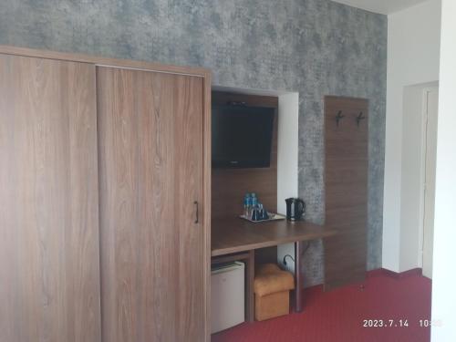 a room with a wooden cabinet and a desk at Lusia in Wisła