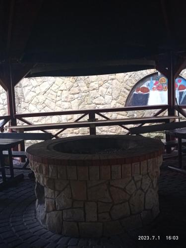 a stone fire pit in front of a building at Lusia in Wisła