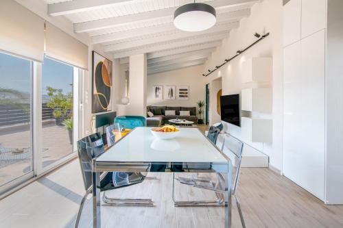 a dining room with a white table and chairs at fragoseco loft! Elegance & Luxury in Chalkida