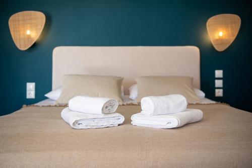a group of towels on top of a bed at fragoseco loft! Elegance & Luxury in Chalkida