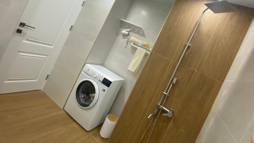 a washer and dryer in a bathroom with a door at Your Sweet Home Gyumri in Gyumri