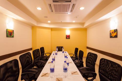 a conference room with a long table and chairs at Ginger Indore in Indore