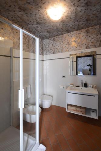 a bathroom with a toilet and a sink and a shower at Braida Wine Resort in Rocchetta Tanaro