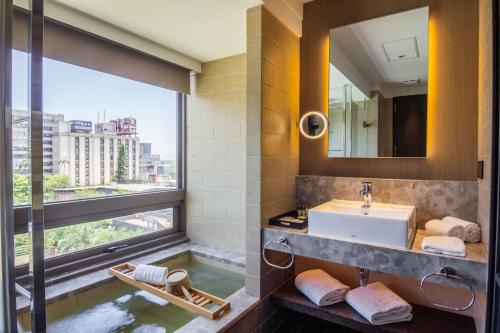 a bathroom with a sink and a large window at Kilin Hotel, JiaoXi in Jiaoxi