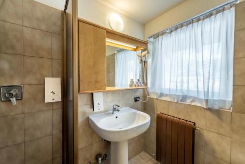 a bathroom with a sink and a mirror at Residence Nevegall in Livigno