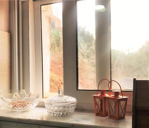 a group of baskets sitting on a window sill at METAXIAS HOUSE in Leonidion