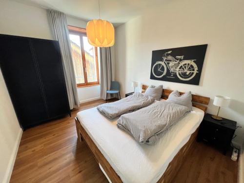 a bedroom with a bed with a bike on the wall at Stay Swiss 1 bedroom apartments in old town in Porrentruy