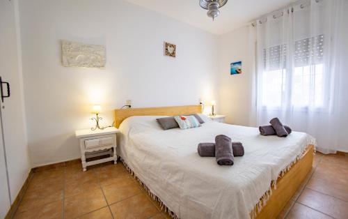 a bedroom with a large bed with two pillows on it at Chalet El Garxal Riumar Pura Natura in Riumar