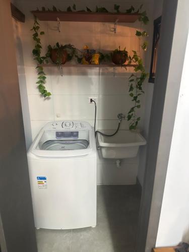 a washer and dryer in a bathroom with a sink at Casa térrea com acessibilidade em Juquehy com piscina climatizada e hidromassagem in Juquei