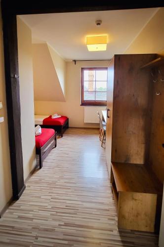 a corridor of a room with two beds and a window at Gościniec Konopielka in Zblewo
