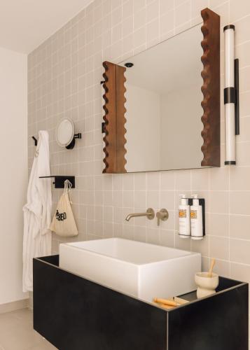 a bathroom with a white sink and a mirror at The Rebello Hotel & Spa - Small Luxury Hotels Of The World in Vila Nova de Gaia