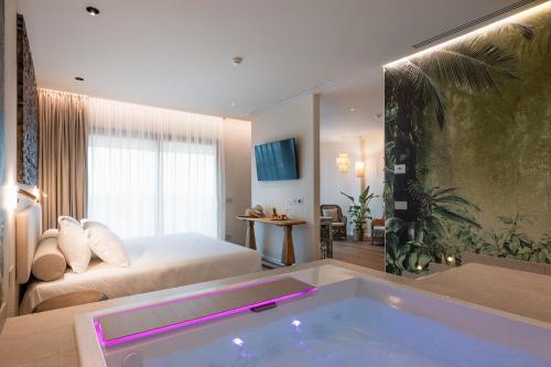 a hotel room with a tub in a bedroom at Savoy Beach Hotel & Thermal Spa in Bibione