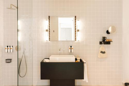 a bathroom with a sink and a mirror at The Rebello Hotel & Spa - Small Luxury Hotels Of The World in Vila Nova de Gaia