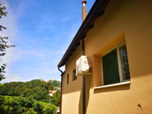 a building with a air conditioner on the side of it at Small house in Celje in Celje