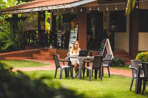 a woman sitting at a table with a laptop at Manglar Lodge in San Carlos
