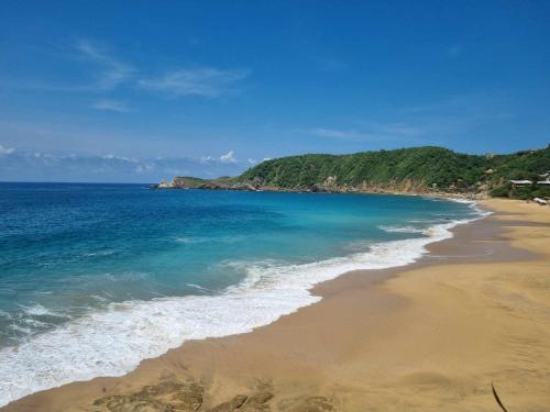 a view of a beach with the ocean at Posada Ziga Playa in Mazunte