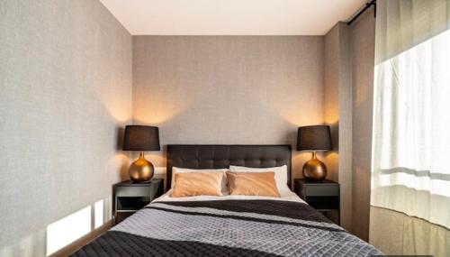 a bedroom with a bed with two lamps on both sides at HOSTAL BEDMATES in Barcelona