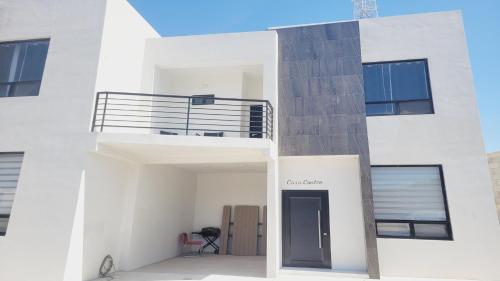 a white apartment building with a black door at New Town Condo Casamar 4 near the beach in Puerto Peñasco