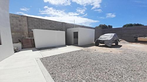 a building with two white doors and a brick wall at New Town Condo Casamar 4 near the beach in Puerto Peñasco