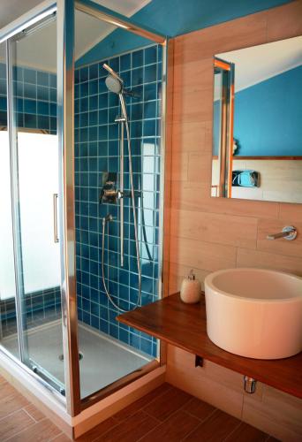 a bathroom with a sink and a shower at B&B DomuSanna in Villaputzu