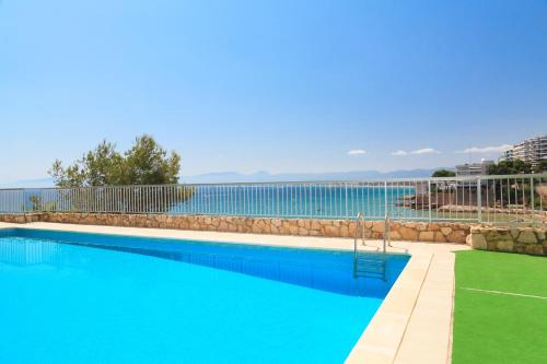 a swimming pool with a view of the water at UHC Bahia Family Complex in Salou
